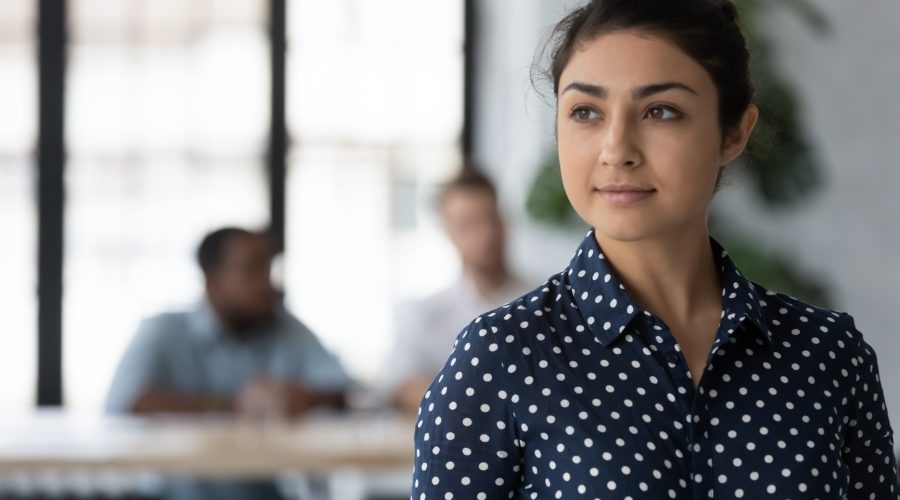 Woman standing out from men in office